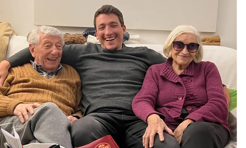 Giorgio on a couch with his grandparents