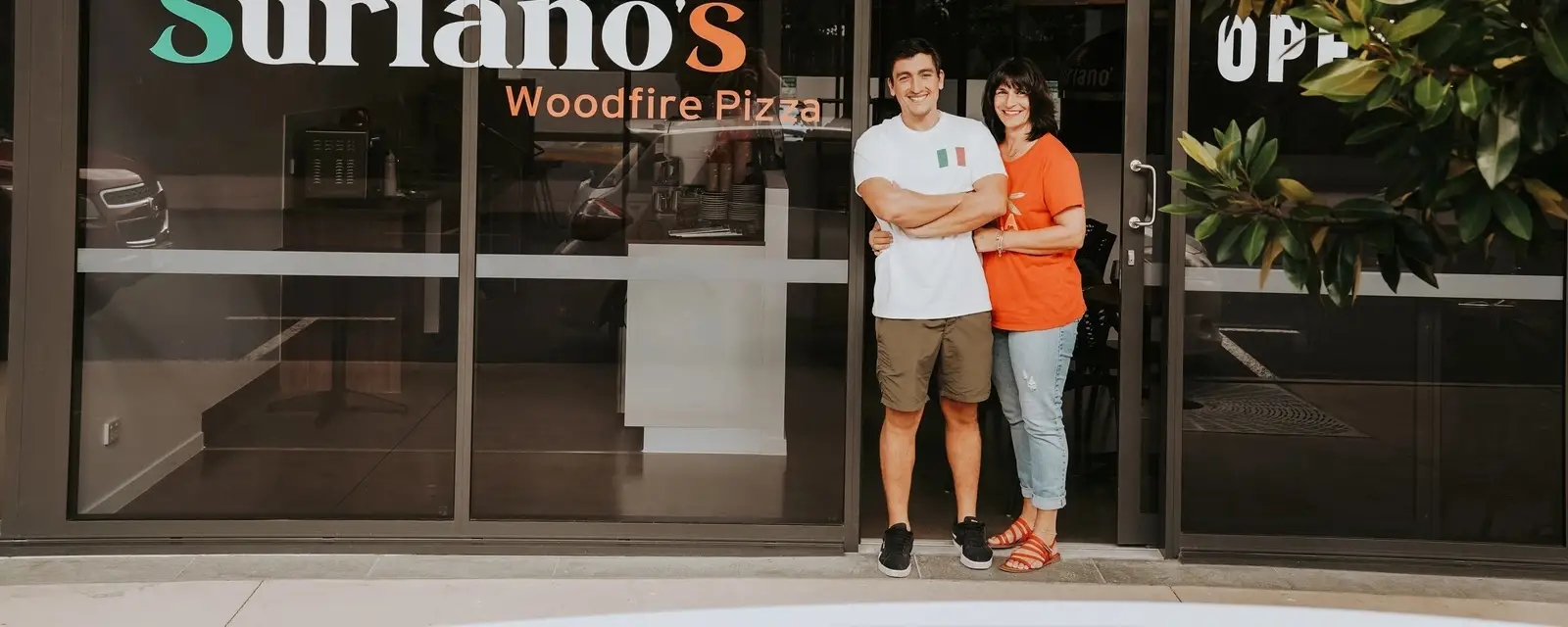 Giorgio and Gianna standing outside Suriano’s on Courage Street